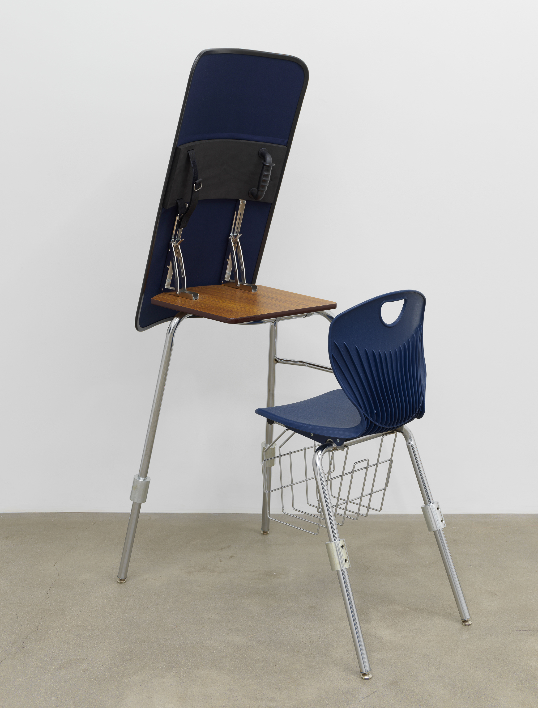 Image of a school blue chair and desk with a blue shield attached