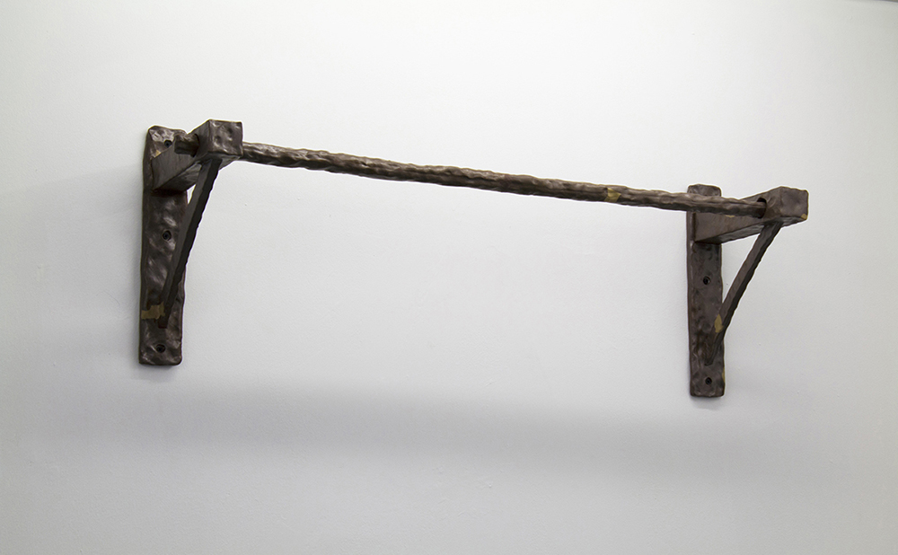 Image of a bronze textured pull-up bar mounted on a wall