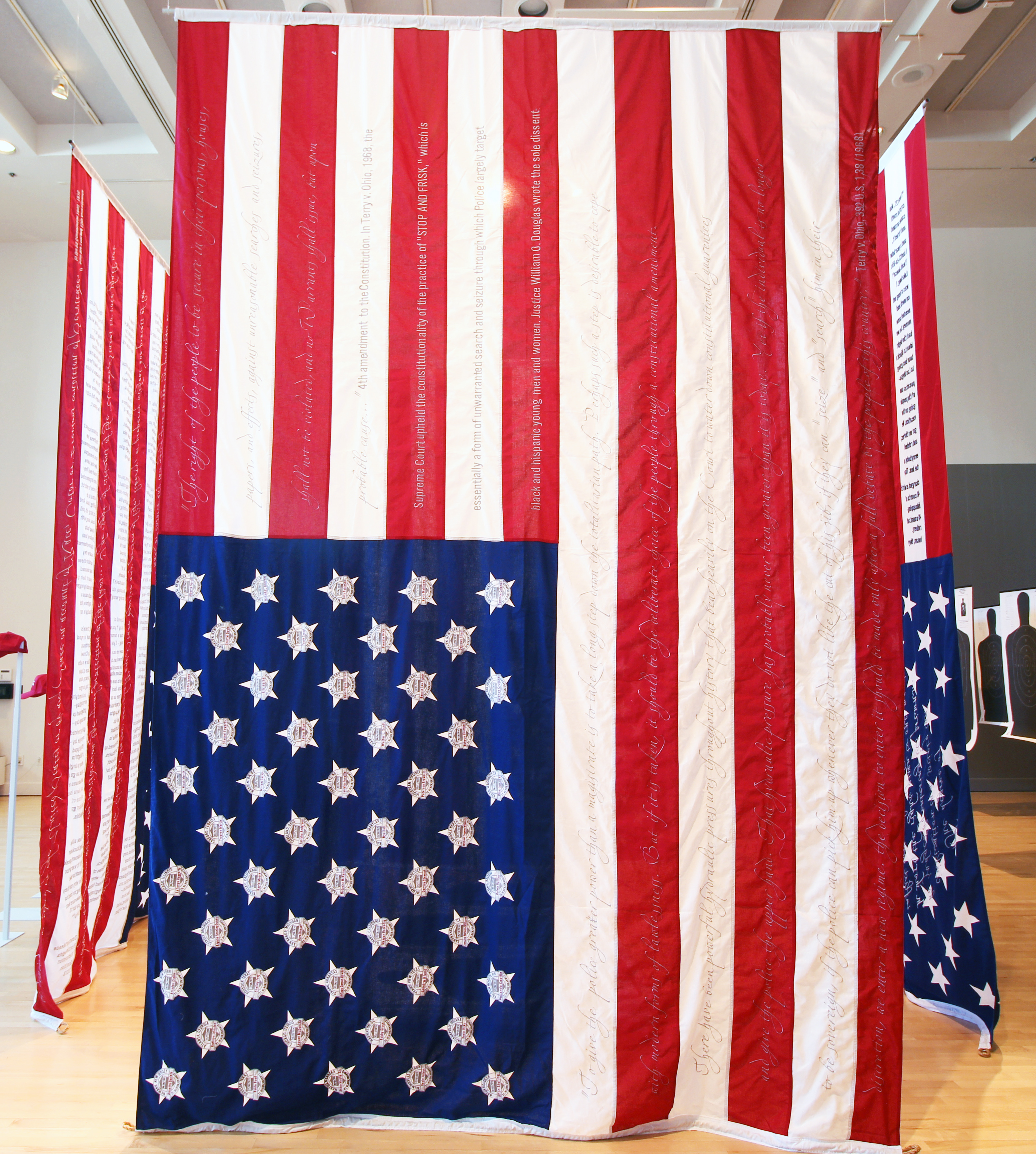 Image of installation with three embroidered U.S. Flags